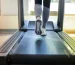 Person_running_on_a_treadmill_with_a_focus_on_their_feet_and_the_treadmill_belt